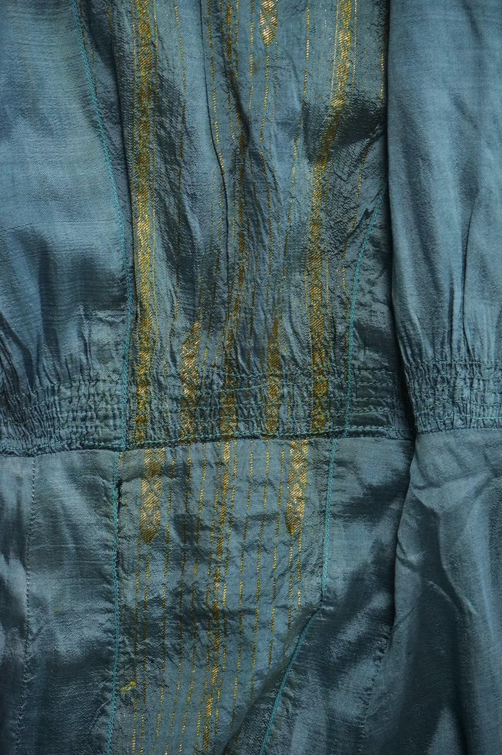 An early 19th century cream silk and metal thread embroidered ladies bonnet, an interesting 1930’s blue silk and gold thread dress fabric designed with Secessionist influences, an earlier fine linen silk embroidered kerc
